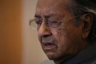 Malaysia's former Prime Minister Mahathir Mohamad reacts during a news conference in Putrajaya