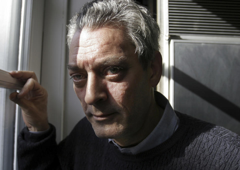 FILE - Writer Paul Auster poses at his home in the Brooklyn borough of New York, Jan. 19, 2006. Paul Auster, a prolific, prize-winning man of letters and filmmaker known for such inventive narratives and meta-narratives as “The New York Trilogy” and “4 3 2 1,” has died at age 77. (AP Photo/Bebeto Matthews, File)