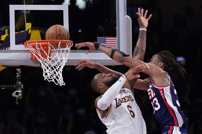 Brooklyn Nets forward Nic Claxton (33) dunks over Los Angeles Lakers forward LeBron James (6) during the second half of an NBA basketball game in Los Angeles, Saturday, Dec. 25, 2021. (AP Photo/Ashley Landis)