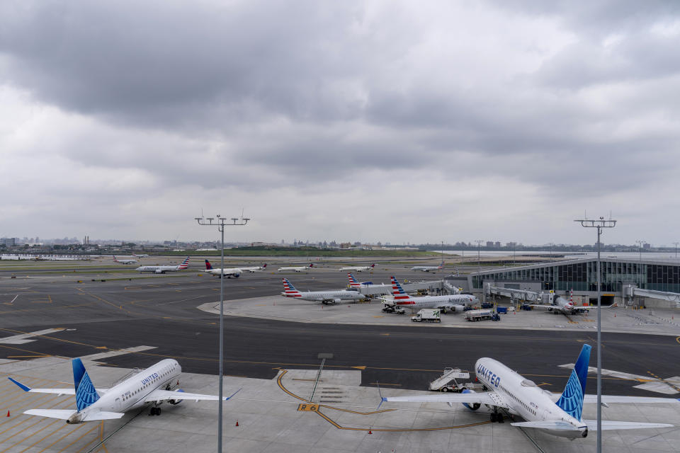 Storm clouds loom over airplane on the tarmac at LaGuardia Airport, Tuesday, June 27, 2023, in New York. Travelers waited out widespread delays at U.S. airports on Tuesday, an ominous sign heading into the long July 4 holiday weekend, which is shaping up as the biggest test yet for airlines that are struggling to keep up with surging numbers of passengers. (AP Photo/Mary Altaffer)