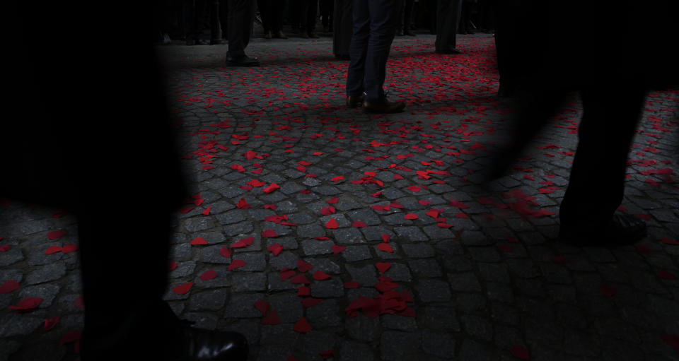 Participants wait after laying wreaths during an Armistice Day ceremony at the Menin Gate Memorial to the Missing in Ypres, Belgium, Thursday, Nov. 11, 2021. (AP Photo/Virginia Mayo)
