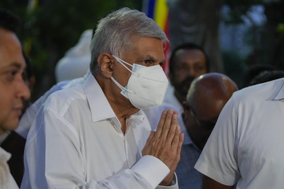 President elect Ranil Wickremesinghe greats supporters upon his arrival at a buddhist temple in Colombo, Sri Lanka, Wednesday, July 20, 2022. Wickremesinghe was elected president Wednesday by lawmakers who opted for a seasoned, veteran leader to lead the country out of economic collapse, despite widespread public opposition. (AP Photo/Eranga Jayawardena)