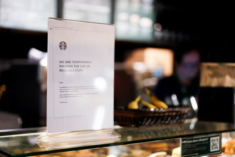 A sign explaining that drinks will not be served in reusable cups is seen inside a Starbucks in London