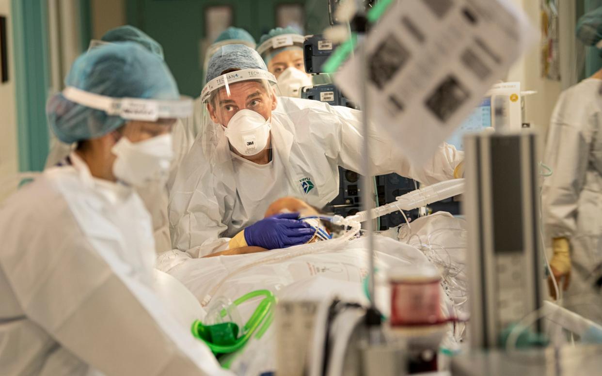 A Covid-19 patient at the Royal Brompton Hospital AICU (Adult Intensive Care Unit) is carefully moved through the corridors to have a CT scan to check lung function - Simon Townsley /The Telegraph