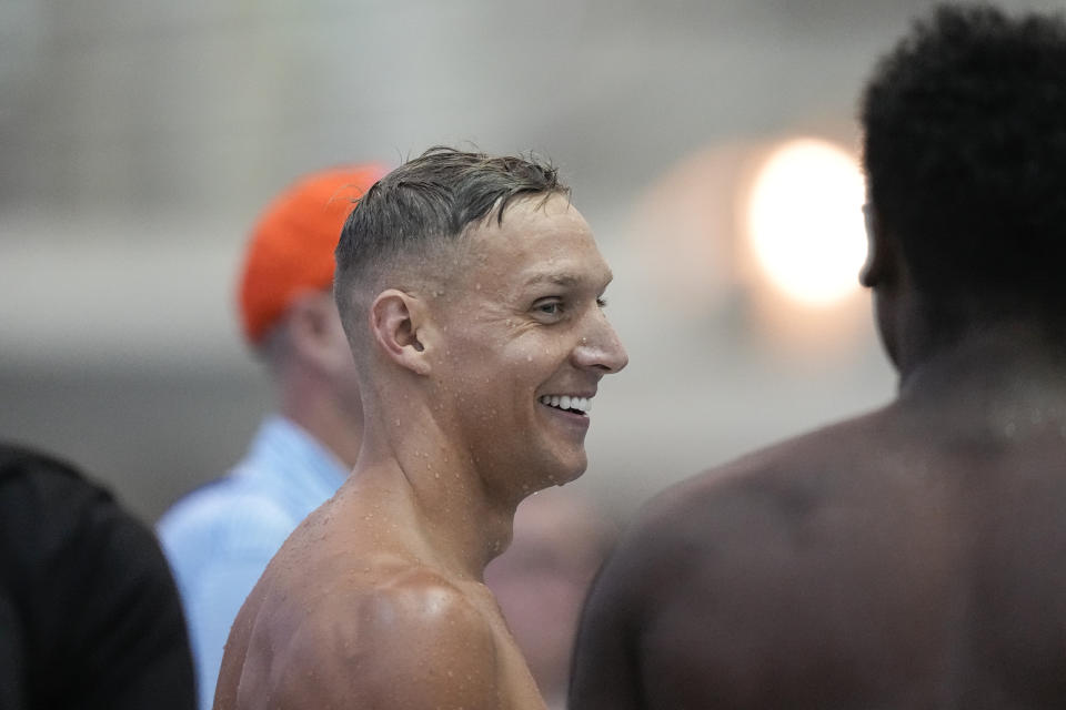 Caeleb Dressel talks with other swimmers after the men's 100 butterfly during the Speedo Atlanta Classic finals Friday, May 12, 2023, in Atlanta. (AP Photo/Brynn Anderson)