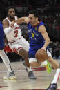 Denver Nuggets guard Facundo Campazzo (7) drives against Chicago Bulls forward Troy Brown Jr. (7) during the first half of an NBA basketball game Monday, Dec. 6, 2021, in Chicago. (AP Photo/Matt Marton)