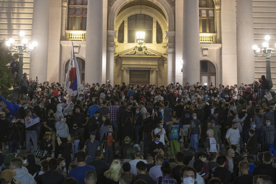 Protesters gather in front of the Serbian parliament in Belgrade, Serbia, Tuesday, July 7, 2020. Thousands of people protested the Serbian president's announcement that a lockdown will be reintroduced after the Balkan country reported its highest single-day death toll from the coronavirus Tuesday. (AP Photo/Marko Drobnjakovic)