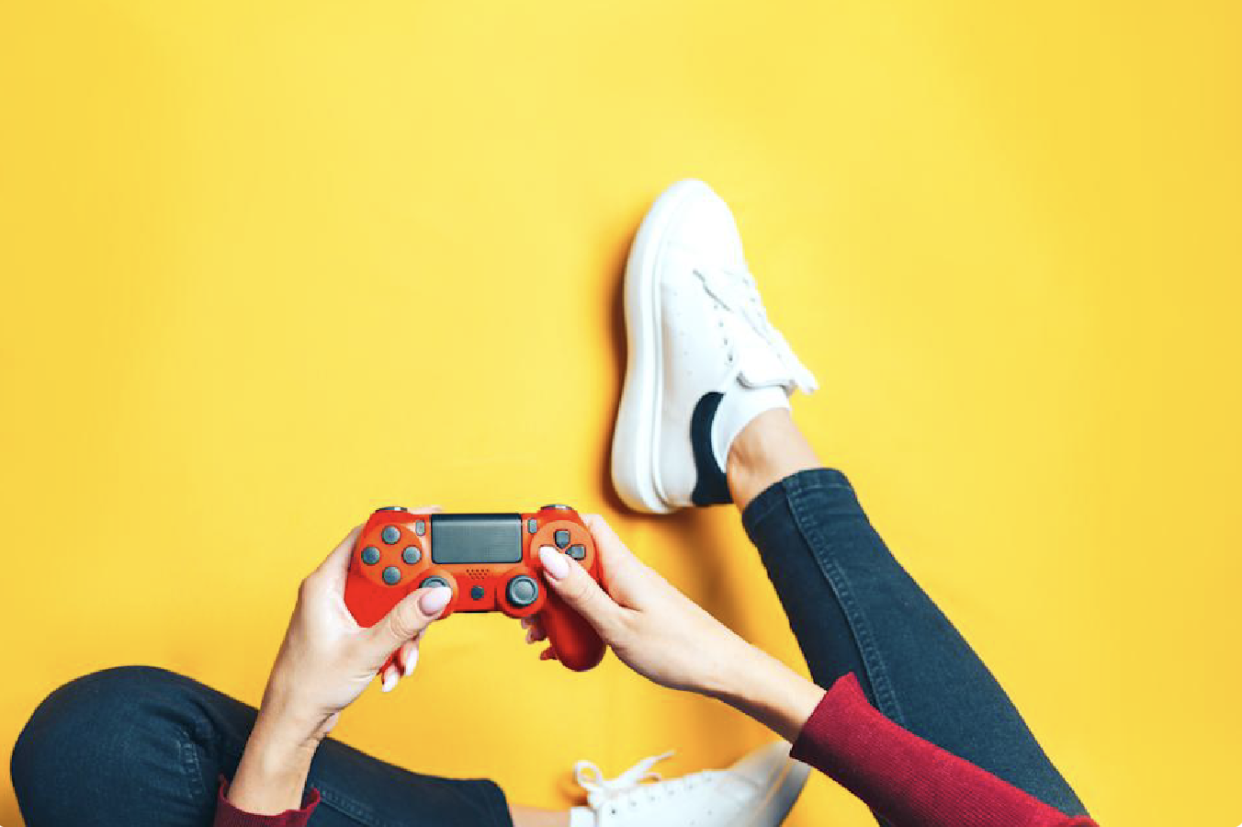 person holding a red video game controller