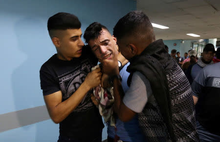 A relative of Palestinian Mohammad Al-Hamayda, who was killed by Israeli forces during a protest at the Israel-Gaza border, reacts at a hospital in the southern Gaza Strip June 29, 2018. REUTERS/Ibraheem Abu Mustafa