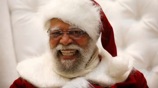 PHOTO: In this Dec. 16, 2013, file photo. Santa Claus Langston Patterson, 77, laughs as he greets children at Baldwin Hills Crenshaw Plaza mall in Los Angeles. (Lucy Nicholson/Reuters, FILE)