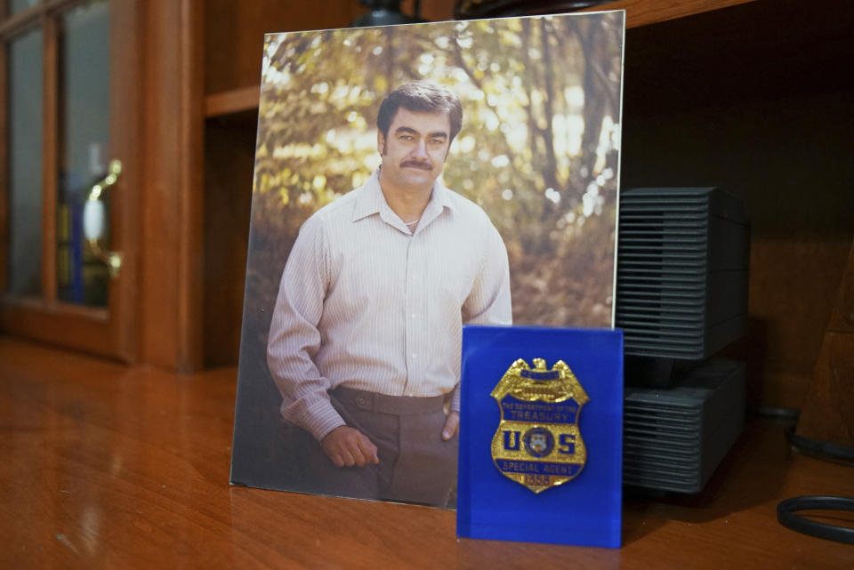 A picture of W. Lloyd Grafton, made during his field agent days, sits next to his badge encased in resin, at his home in Ruston, La. “There’s a corruption that allows the reprobates in state police to just sort of do as they damn well please,” says Grafton, a former federal officer, past member of the Louisiana State Police Commission and an expert court consultant on police use of force. “Nobody holds them accountable.” (AP Photo/Allen G. Breed)