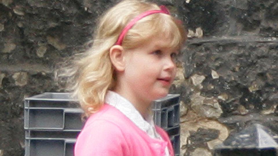 Lady Louise Windsor wearing a pink cardigan and white dress