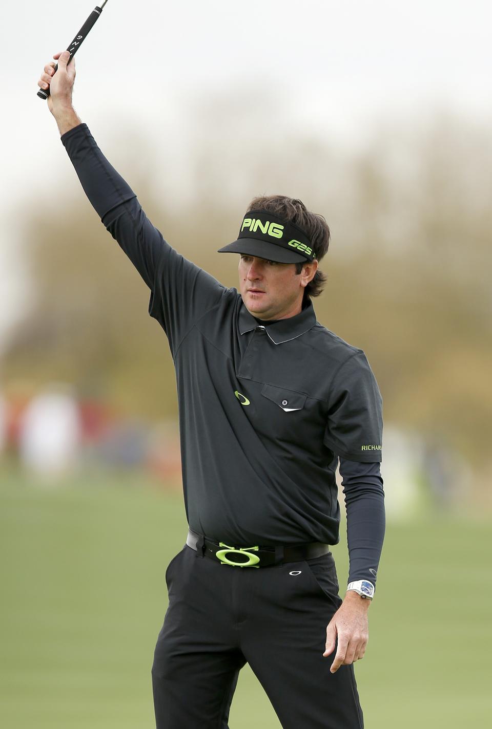 Bubba Watson raises his arm after making a birdie putt on the eighth hole during the second round of the Phoenix Open golf tournament on Friday, Jan. 31, 2014, in Scottsdale, Ariz. (AP Photo/Ross D. Franklin)