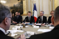 French President Emmanuel Macron, center, French Prime Minister Edouard Philipppe, left, and Environment Minister Francois de Rugy, second right, and Labor Minister Muriel Penicaud meet with representatives of trade unions, employers' organizations and local elected officials at the Elysee Palace in Paris, Monday, Dec.10 2018. Macron is preparing to speak to the nation Monday at last, after increasingly violent and radicalized protests against his leadership and a long silence that aggravated the anger. (Yoan Valat, Pool via AP)