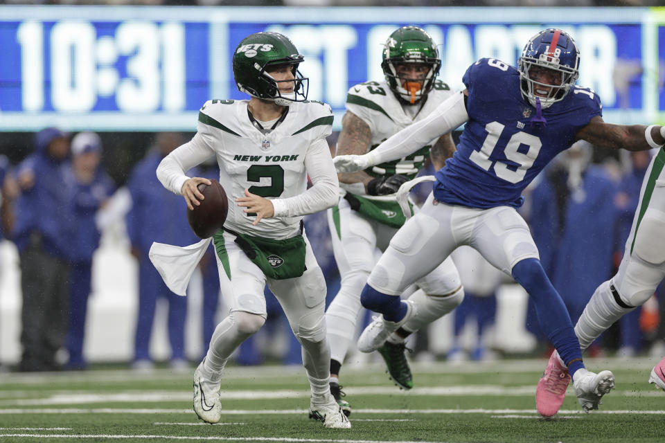 New York Jets quarterback Zach Wilson (2) looks to pass under pressure by New York Giants safety Isaiah Simmons (19) during the first half of an NFL football game, Sunday, Oct. 29, 2023, in East Rutherford, N.J. (AP Photo/Adam Hunger)