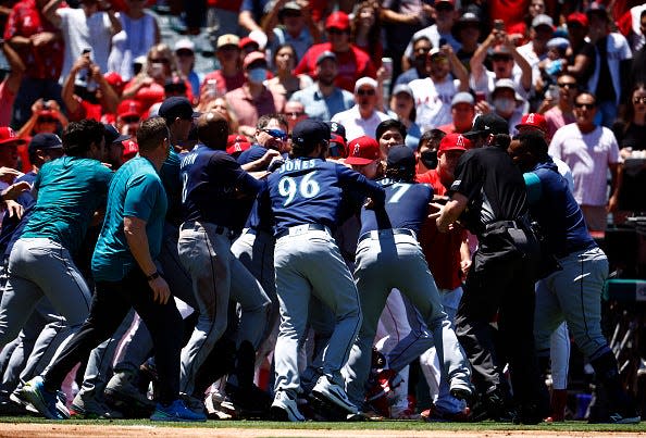 The Seattle Mariners and the Los Angeles Angels clear the benches after Jesse Winker #27 of the Seattle Mariners charged the Angels dugout after being hit by a pitch in the second inning at Angel Stadium of Anaheim on June 26, 2022 in Anaheim, California.