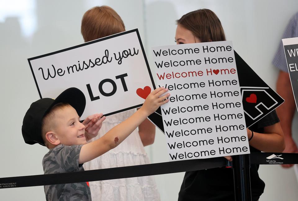 Wesley Titensor, Hannah Jackson and Sadie Jackson hold signs as they wait for Elder McCade Cefalo to arrive home from serving a mission on Tuesday, June 20, 2023, at the Salt Lake City International Airport in Salt Lake City. | Kristin Murphy, Deseret News