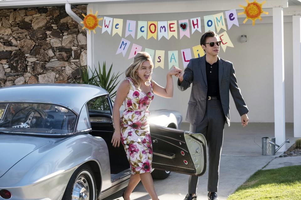 Alice and Jack in front of a sign that says "Welcome Home Miss Alice"