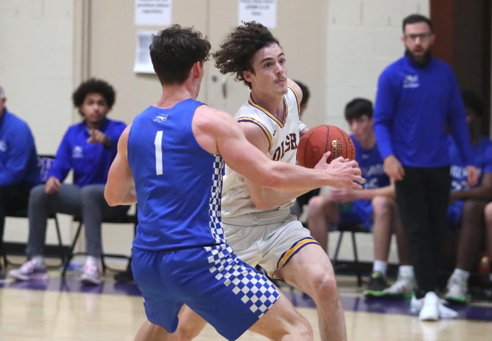 OLSH's Rocco Spadafora drives to the basket while being guarded by South Park's Tyler Susan during the first half Friday night at Our Lady of the Sacred Heart High School.