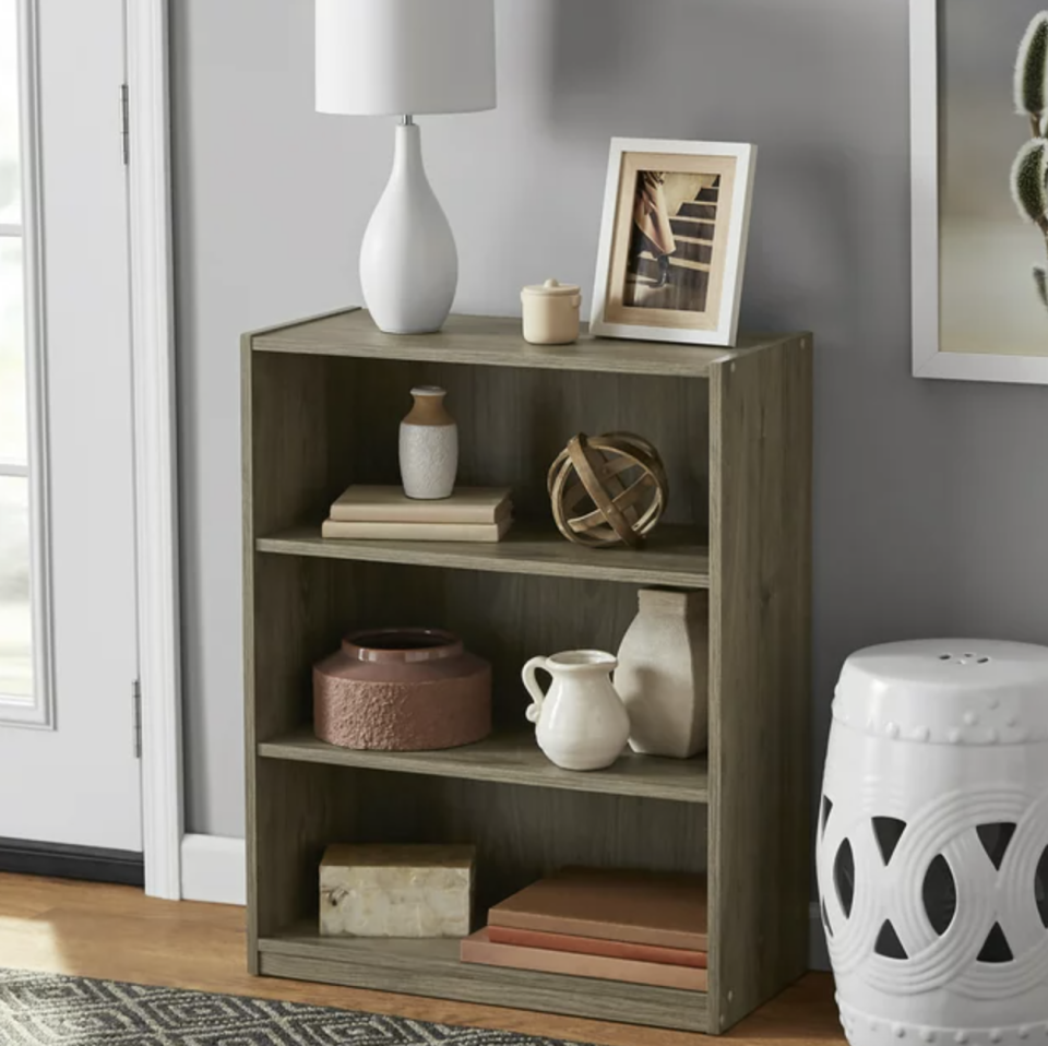 light brown wooden side shelf with three shelves