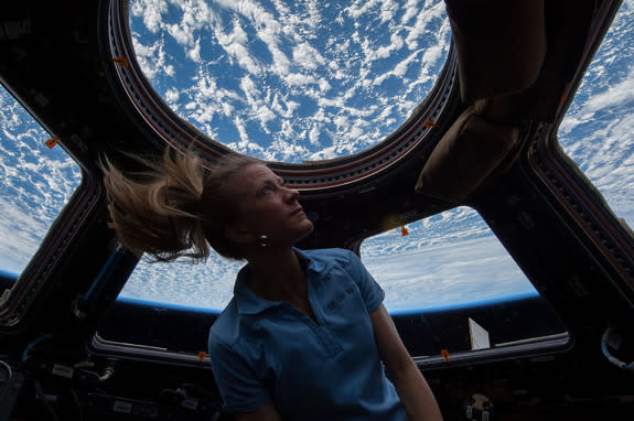 NASA astronaut Karen Nyberg enjoys the view of Earth from the windows in the Cupola of the International Space Station during her Expedition 37 mission in 2013. Image taken Nov. 4.