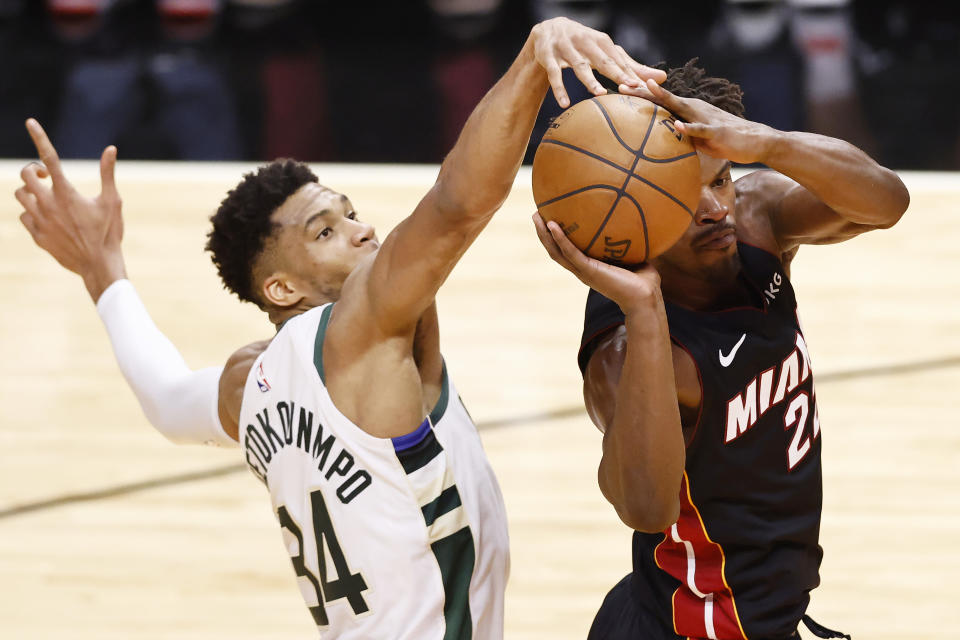 MIAMI, FLORIDA - MAY 27: Giannis Antetokounmpo #34 of the Milwaukee Bucks defends a shot by Jimmy Butler #22 of the Miami Heat during the second quarter in Game Three of the Eastern Conference first-round playoff series at American Airlines Arena on May 27, 2021 in Miami, Florida. NOTE TO USER: User expressly acknowledges and agrees that, by downloading and or using this photograph, User is consenting to the terms and conditions of the Getty Images License Agreement. (Photo by Michael Reaves/Getty Images)