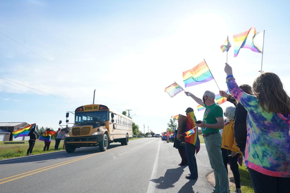 Across Canada, we are witnessing a surge of unrest surrounding 2SLGBTQIA+ policy changes. Supporters wave flags to show support for students at East Wiltshire School in Cornwall, P.E.I., in June 2021. THE CANADIAN PRESS/John Morris