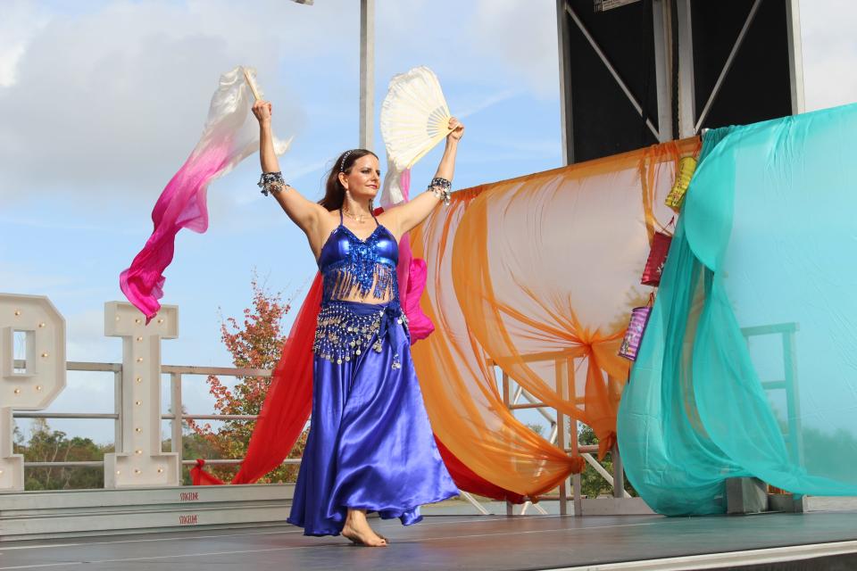 Salwa Brannen performs a belly dance as the incoming storm brews up stronger winds. HerSavannah AAPI Festival 2022.
