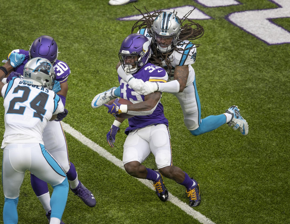 Carolina Panthers free safety Tre Boston (33) tackles Minnesota Vikings running back Dalvin Cook (33) in the first quarter of an NFL football game in Minneapolis, Sunday, Nov. 29, 2020. (Jerry HoltStar Tribune via AP)