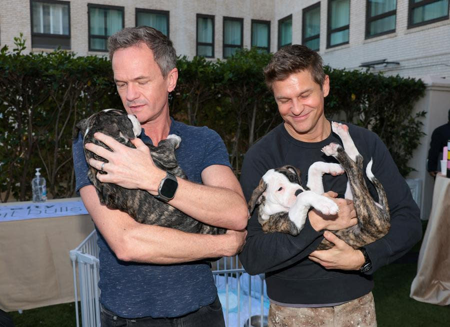 (Left to Right) Neil Patrick Harris and David Burtka get some puppy cuddling time at the GBK Brand Bar pre-Oscar luxury lounge, presented by CareA2+ at the Beverly Wilshire, A Four Seasons Hotel in Beverly Hills. (Photo by Tiffany Rose/Getty Images for GBK Brand Bar)