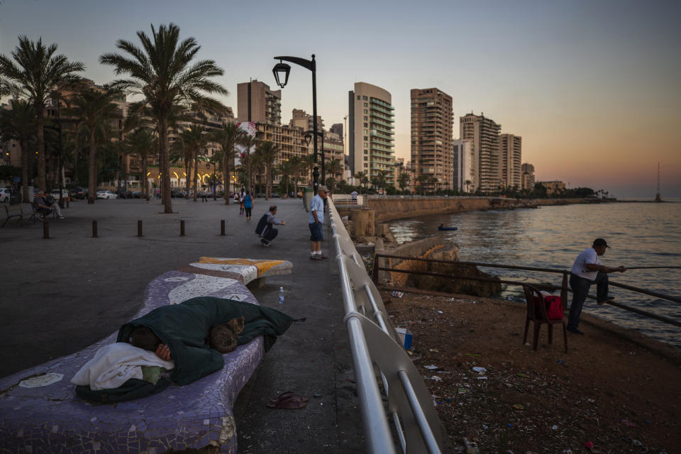 A homeless Lebanese woman and her cat sleep on a bench as the sun rises over the Mediterranean Sea in Beirut, Lebanon, Friday, June 18, 2021. With virtually no national welfare system, Lebanon’s elderly are left to fend for themselves amid their country’s economic turmoil. (AP Photo/Hassan Ammar)