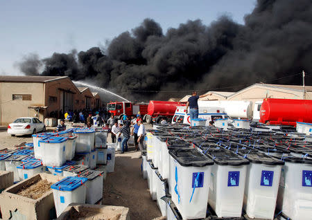 FILE PHOTO: Smoke rises from a storage site in Baghdad, housing ballot boxes from Iraq's May parliamentary election, Iraq June 10, 2018. REUTERS/Khalid al-Mousily /File Photo