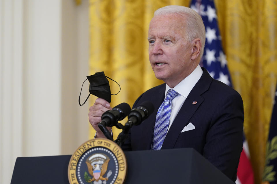 President Joe Biden holds a face mask as he announces from the East Room of the White House in Washington, Thursday, July 29, 2021, that millions of federal workers must show proof they've received a coronavirus vaccine or submit to regular testing and stringent social distancing, masking and travel restrictions in an order to combat the spread of the coronavirus. (AP Photo/Susan Walsh)