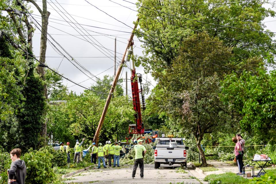 A snapped power pole damaged from the storm on Thursday, July 13, 2023, on Lansing's east side.