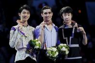 Figure Skating - ISU World Figure Skating Championships - Mens Free Skate Program - Boston, Massachusetts, United States - 01/04/16 - Silver medalist Yuzuru Hanyu (L) of Japan, gold medalist Javier Fernandez (C) of Spain, and bronze medalist Jin Boyang of China pose for photographs on the awards podium. - REUTERS/Brian Snyder