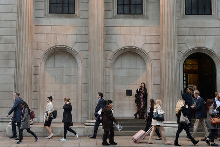 City workers make their way home past the Bank of England in the City of London, Britain October 18, 2017. Picture taken October 18, 2017. REUTERS/Mary Turner