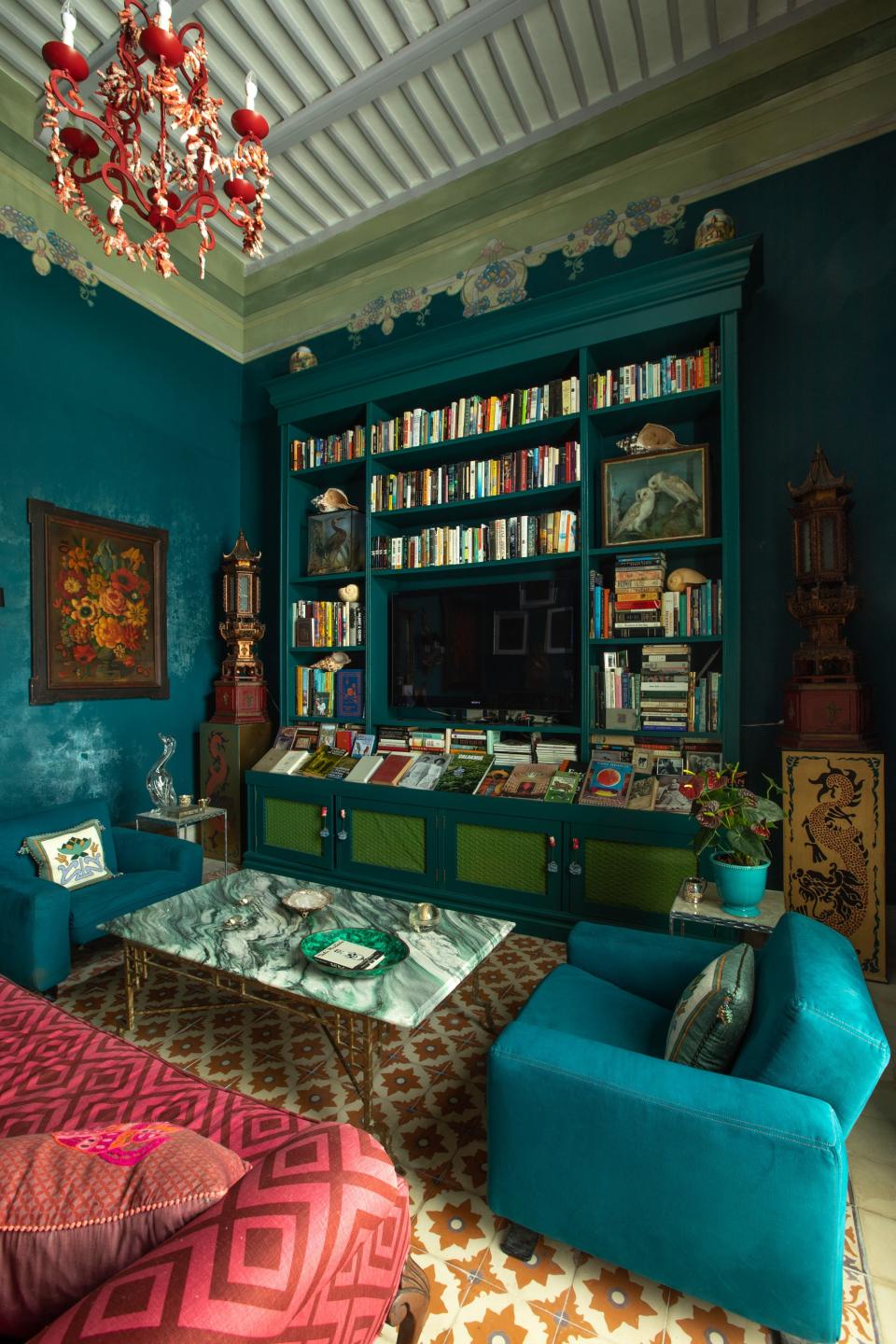 The biblioteca’s original wall stencils and beamed ceiling were restored, and Skouras filled the room with one of her coral light fixtures, a custom cocktail table she designed with a granite top, and chairs from Cassina that once belonged to her parents. The sofa fabric is a David Hicks linen.