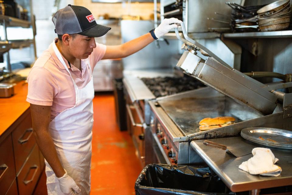 Diego Santiago toasts a meatball sub at Nick's in Fort Collins on Wednesday. The downtown Italian restaurant opened the lunch-only, grab-and-go sandwich shop on Monday.