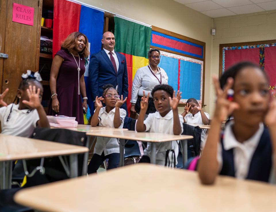 Detroit Public Schools Community District board president Angelique Peterson-Mayberry, left, and Detroit Public Schools superintendent  Nikolai Vitti stand with Foreign Language Immersion and Cultural Studies School principal Zetia Hogan as they visit a French class during the first day of school at F.L.I.C.S. in Detroit on August 29, 2022.