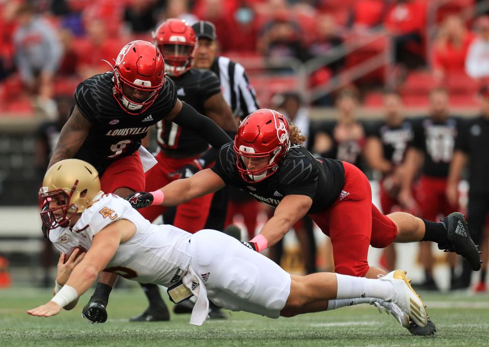 Louisville's Ashton Gillotte rushes to tackle Boston College quarterback Dennis Grosel in a October 2021 home game.