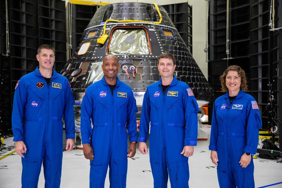 Artemis II crew members, shown inside the Neil Armstrong Operations and Checkout Building at NASA’s Kennedy Space Center in Florida, stand in front of their Orion crew module on Aug. 8, 2023. From left are: Jeremy Hansen, mission specialist; Victor Glover, pilot; Reid Wiseman, commander; and Christina Hammock Koch, mission specialist.