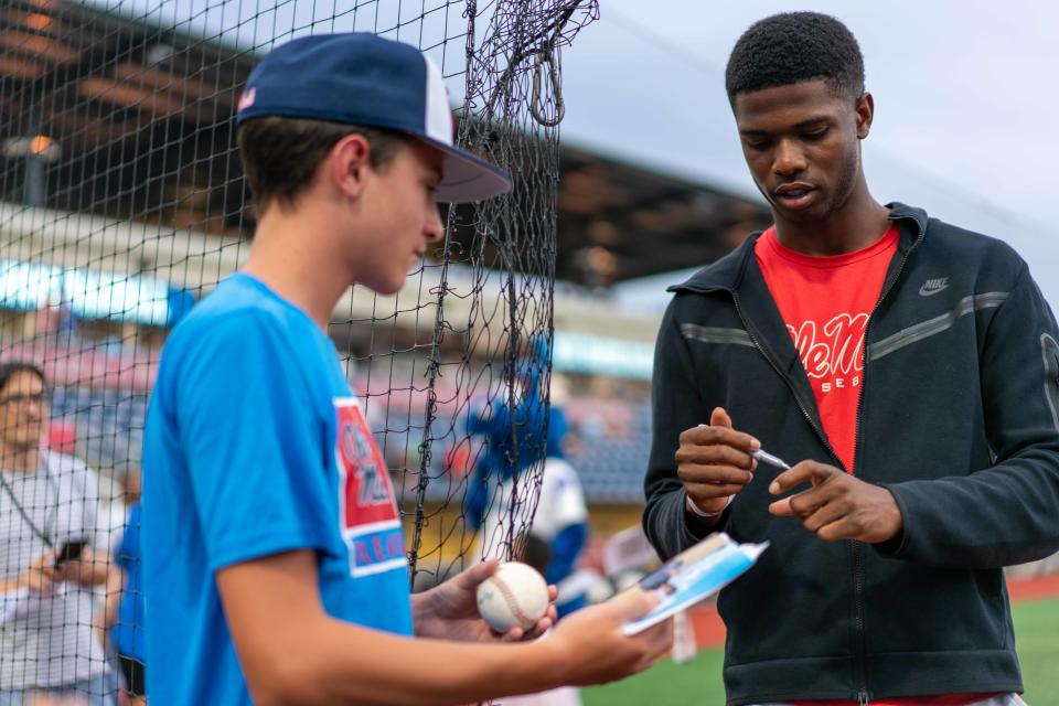 Pensacola Catholic alum and Ole Miss outfielder T.J. McCants signs autographs prior to tossing the first pitch in Tuesday's Pensacola Blue Wahoos' game against the Chattanooga Lookouts on  July 12, 2022 from Blue Wahoos Stadium.