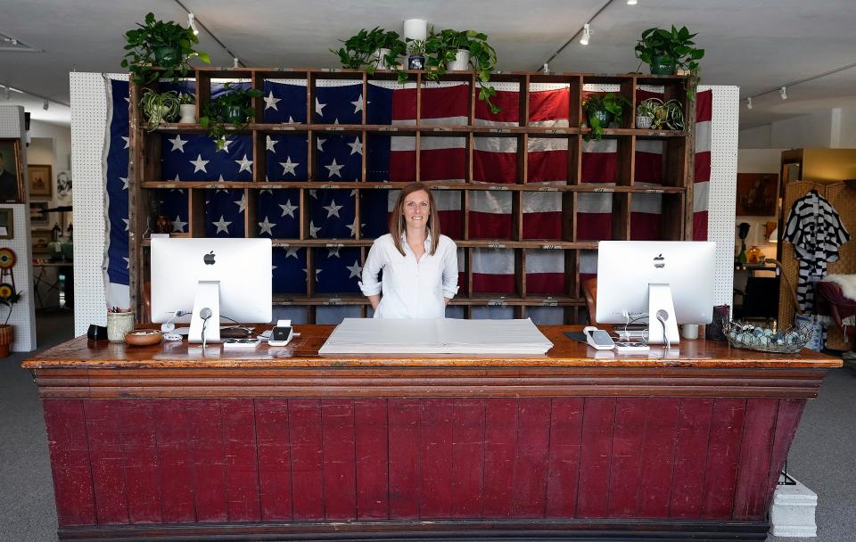 Eclectiques Antique Mall owner Abbey Simeral poses for a photo before the store reopened in April.