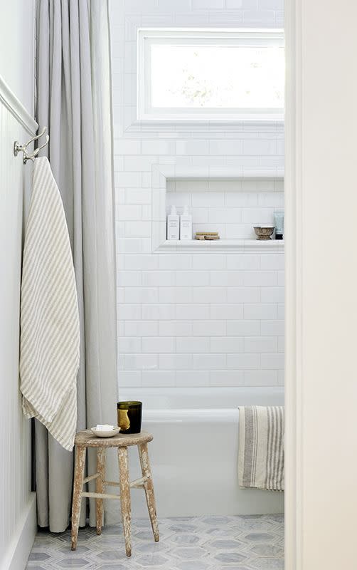 white bathtub with gray and white patterned floor