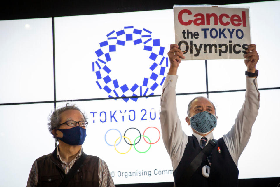 A protester holds a placard during a protest against the Tokyo Olympics on in Tokyo, Japan. 