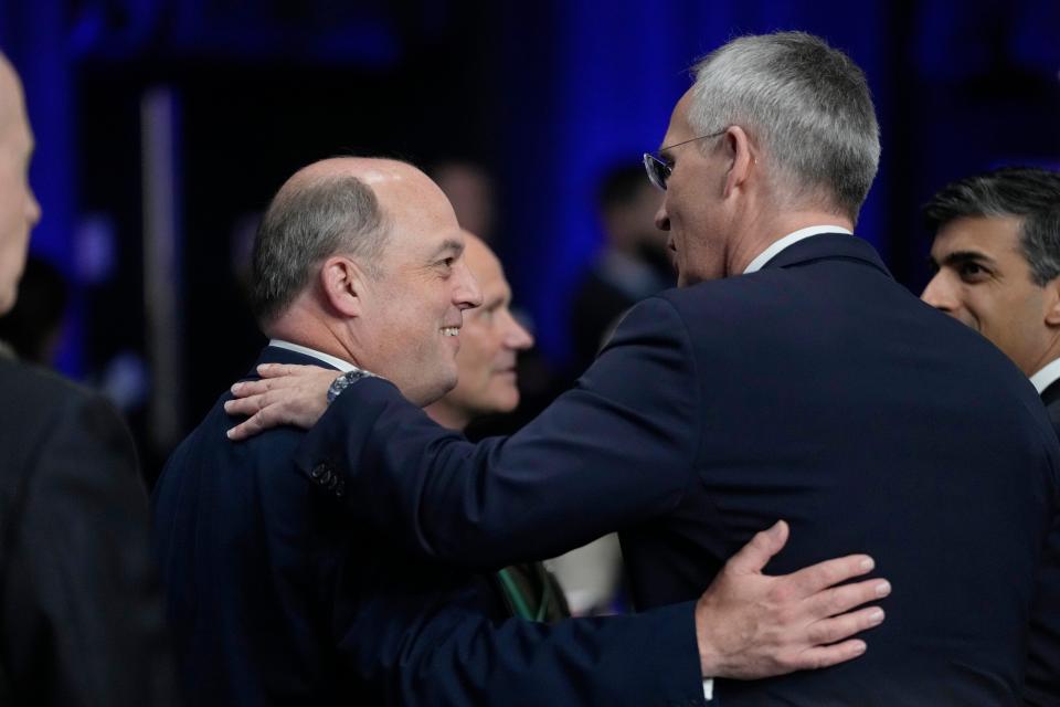 Ben Wallace, left, speaks with NATO Secretary General Jens Stoltenberg during a NATO summit in Vilnius (AP)