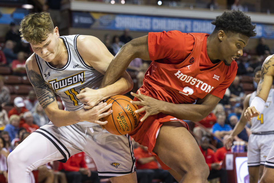 Houston's Cedric Lath, right, fights for a rebound with Towson's Chase Pear, left, in the second half of an NCAA college basketball game during the Charleston Classic in Charleston, S.C., Thursday, Nov. 16, 2023. (AP Photo/Mic Smith)