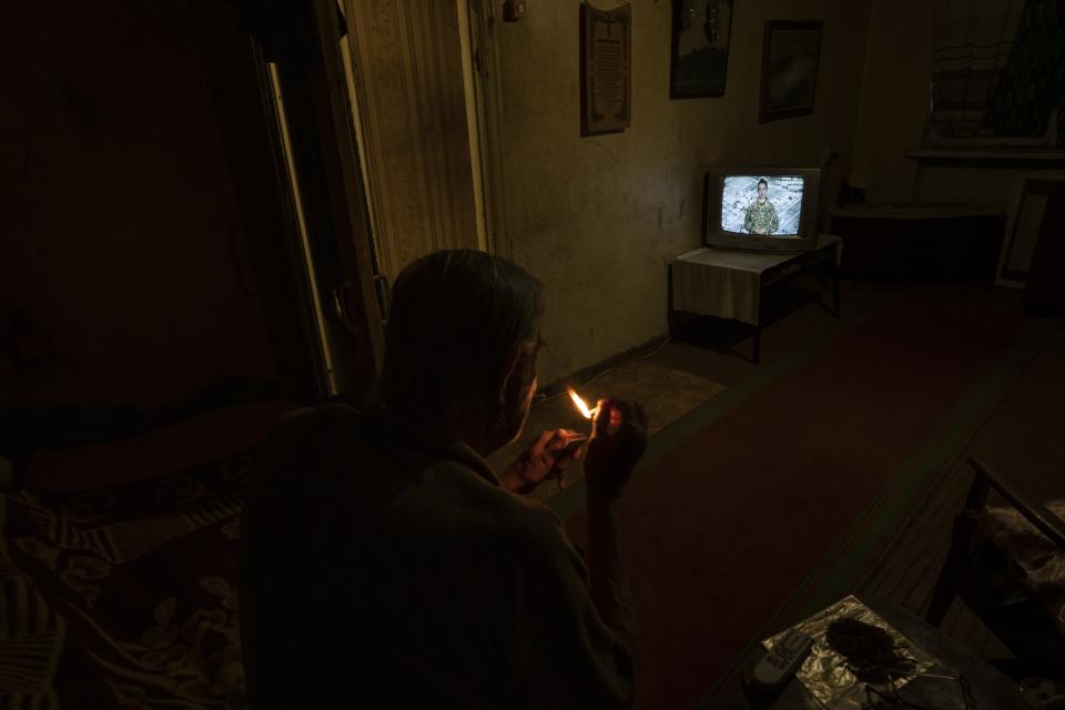 Valerii Ilchenko, 70, who lives alone and is refusing to evacuate, watches television in his apartment, in Kramatorsk, eastern Ukraine, July 6, 2022. The image was part of a series of images by Associated Press photographers that was a finalist for the 2023 Pulitzer Prize for Feature Photography. (AP Photo/Nariman El-Mofty)