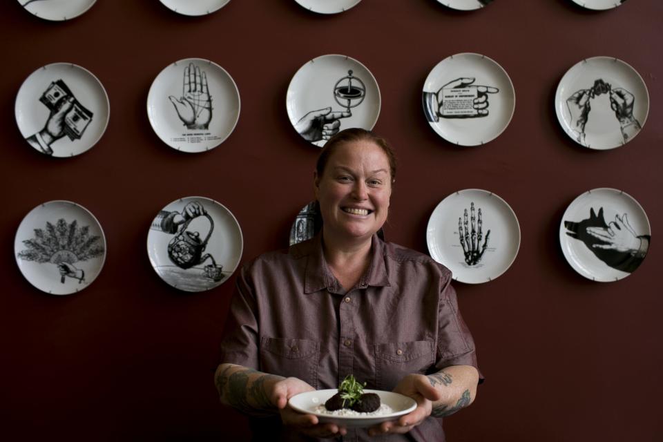 FnB chef and co-owner Charleen Badman holds falafel at FnB restaurant in Scottsdale.