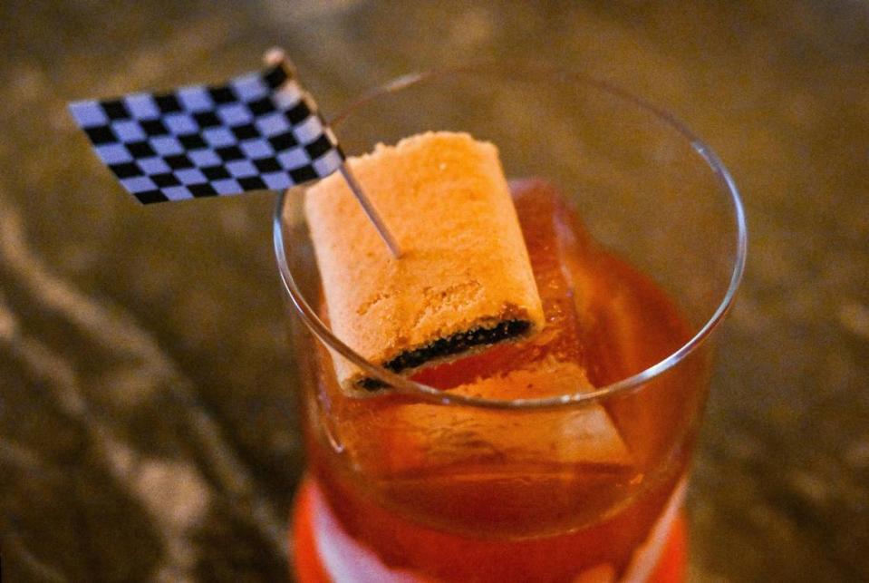 A Ricky Bobby cocktail, named for the movie “Talladega Nights: The Ballad of Ricky Bobby,” features cereal-infused bourbon, a Fig Newton, and a racing flag at The Red Room, a new bar opening inside Pardini’s catering venue on West Shaw Avenue in Fresno.